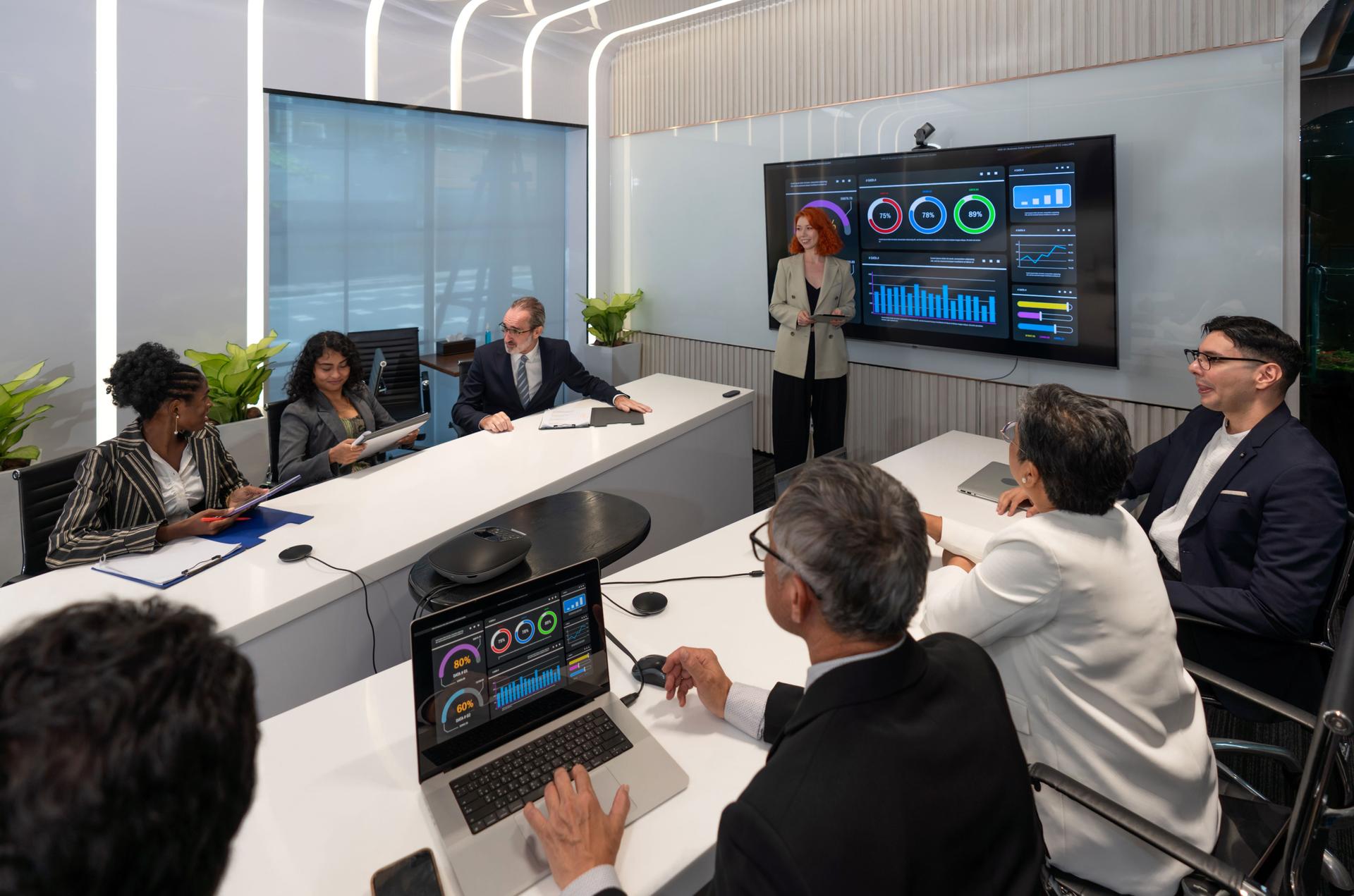 Business presentation in modern conference room showcasing data analysis and strategic planning with engaged audience participation.
