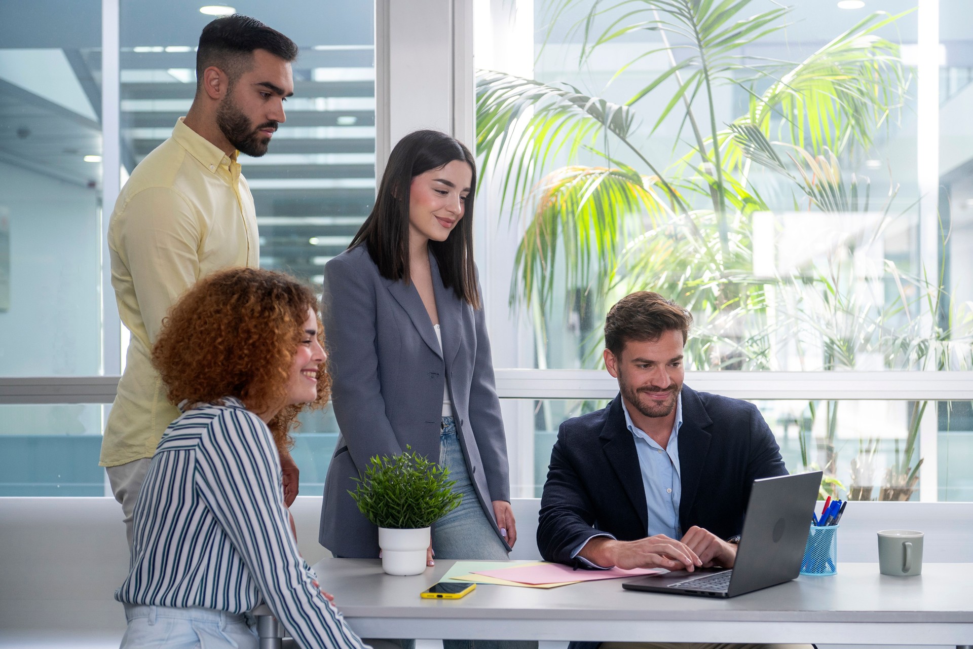 Business team collaborating on a project using laptop in the office